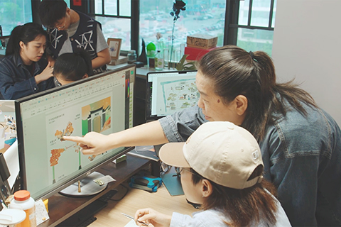 ◎ 二0二五年九月廿二日,戴翎怡(前排右)與團隊討論文創產品設計。(王鑫 攝)