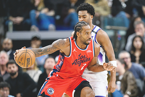 ◎ 二0二六年一月一日於加州英格伍德舉行的NBA常季賽下半場,洛杉磯快艇前鋒Kawhi李奧拿德(左),在猶他爵士前鋒森沙巴的壓力下推球前進。(美聯社/William Liang)