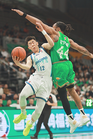 ◎ 一月十三日,CBA常規賽第十四輪比賽中,遼寧本鋼隊主場七十比八十六負青島嶗山啤酒隊。圖為青島嶗山啤酒隊球員段昂君(左)在比賽中。(中新社記者于海洋攝)