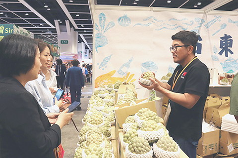 ◎ 八月十三日,第三十六屆美食博覽在香港會議展覽中心開幕。圖為台灣台東展區的參展商向消費者介紹大目釋迦。( 張語洽 攝)