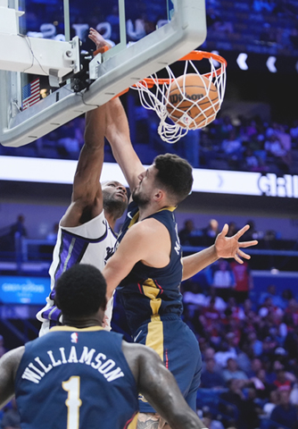 ◎ 十月二十九日,在新奧爾良舉行的NBA籃球比賽下半場,薩克拉門托帝王隊前鋒德安德烈.亨特扣籃,對手是新奧爾良鵜鶘隊前鋒卡洛.馬特科維奇。(美聯社照片/謝拉特赫伯特)